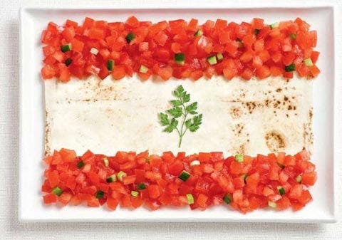 Lebanese flag made out of tomatoes, cucumber, bread and parsley