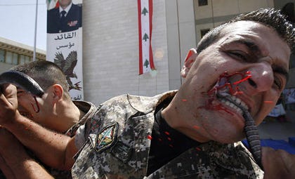 Lebanese soldier biting off snake's head
